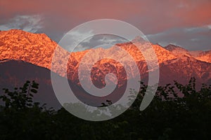 Flaming sunset over snowpeaked Indian himalayas