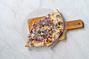 Flammkuchen Pizza Slices / Traditional Tarte Flambee with Creme Fraiche, Cream Cheese, Bacon and Red Onions on Wooden Board