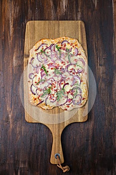 Flammkuchen - Traditional French dish tarte flambee cream cheese, bacon and onions