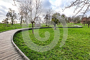 Flanders organic orchard at Alden Biesen Castle with curved wooden bridge