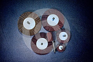 Flap Wheel. A pile of color abrasive Flap Wheel industrial on wood background texture. sandpaper wheel tool - professional equipme