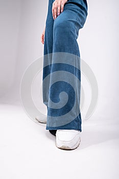 flared trousers, blue, worn on a girl, close-up