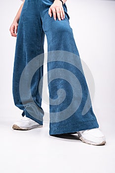 flared trousers, blue, worn on a girl, close-up