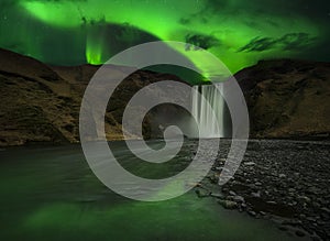 Flash of Aurora polaris above waterfall