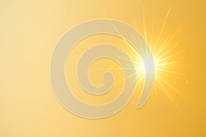 A flash of light on a golden background. Space for text.