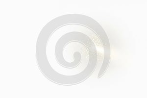 A flash of light and sparks on a light background. Space for text.