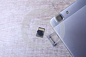 Flash memory data storage concept : A tray with a micro SD card on white background. A memory card is used for storing digital