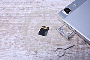 Flash memory data storage concept : A tray with a micro SD card on white background. A memory card is used for storing digital