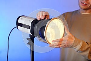 A flash with a modifier on with a diffuser with a person