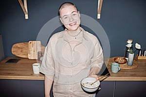 Flash Portrait Of Young Woman In Kitchen