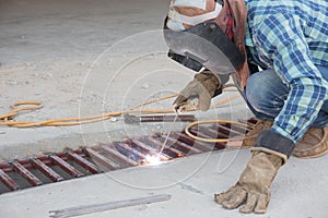 Flash and spark from welding metal at construction site photo