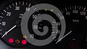 A flashing emergency warning light on the instrument panel in a car with flashing malfunction indicators