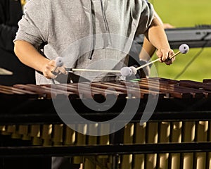 flashing mallets of the sideline percussionists at rehearsal