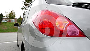 Flashing orange blinker light on rear lamp