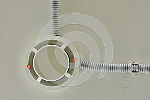 Flashing red lights fire alarm system on the ceiling in the room building. Smoke detector fire alarm sensor