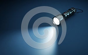 Flashlight and beam of light on a dark background