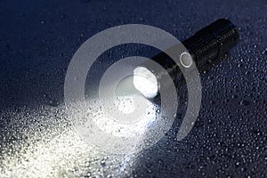 Flashlight on wet surface