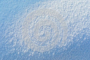 Flat background of snow with sunshine in the center