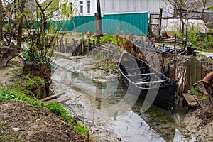 A flat-bottomed boat in the Ukrainian city of Vilkovo. The city was built in the Danube Delta. People move on the water in boats.