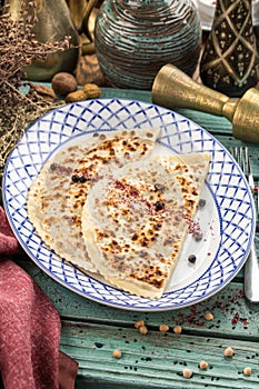 Flat bread qutab on blue wooden table traditional Azerbaijani cuisine