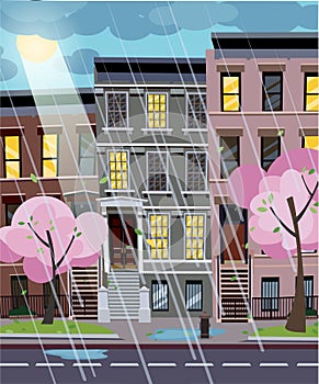 Flat cartoon vector illustration of spring rainy city street at evening. Uneven houses with lighting windows. Cityscape with rain