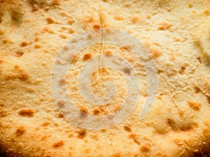Flat closed Ossetian pie close up