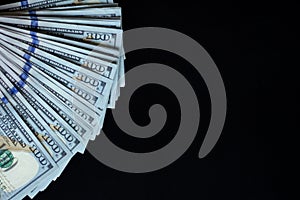 Flat closeup of fan dollars on black background. Success concept. Finance investment concept. Dollar sign. Hundred dollar bill
