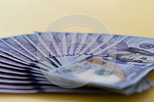 Flat closeup of fan dollars on yellow background. Investment profit income. Success concept. Finance investment concept. Dollar