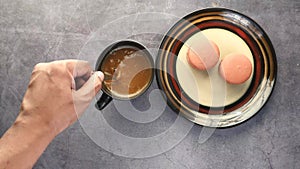 flat composition of person hand stirring coffee with spoon.