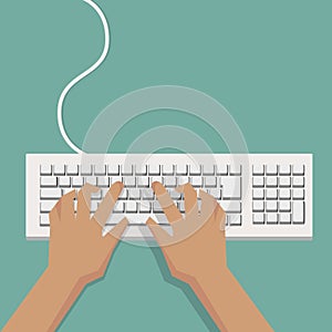 Flat Hands typing on white keyboard with cable photo