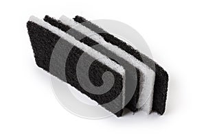 Flat hard fleecy synthetic cleaning sponges on a white background