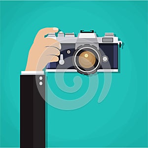 Flat illustration of photo camera with hand holding it