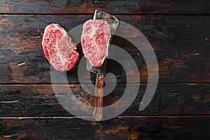 Flat iron steak, raw meat, marbled beef Top blade chuck cut on metal butcher cleaver knife top view space for text