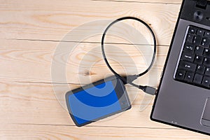Flat lay above lap top computer keyboard and external hard disc with copy space