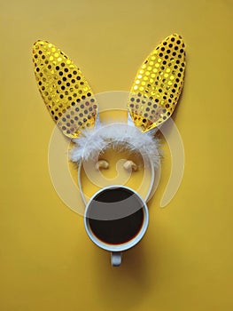 Flat lay accessory costume bunny ears on beautiful yellow background at home office desk. Creative concept of happy Easter.