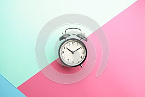alarm clock gainst color background photo