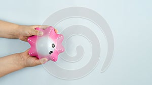 Flat lay antistress toy squish pink star in hands on Blue background.