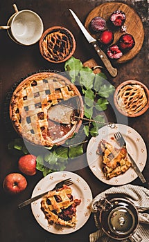 Flat-lay of apple and plum pie on rack with tea