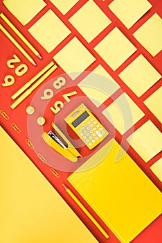 flat lay with arranged yellow schooling supplies in rows