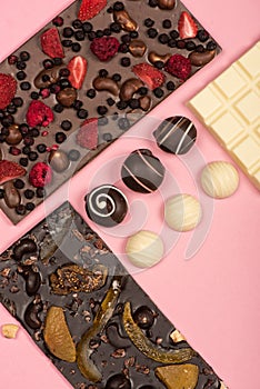 Flat lay with assorted chocolate bars with fruits and nuts and candies