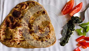 Flat Lay of authentic Punjabi dish, parantha or paratha served with coriander mint chutney,salad.Closeup,dhaba style,indian food.