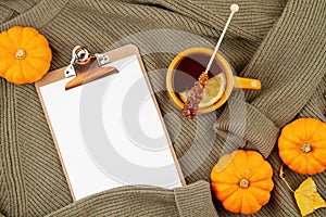 Flat lay autumn composition with tea and a warm woolen sweater