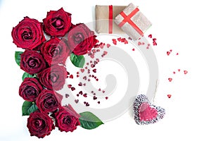 Flat Lay Background, flower pattern, Valentine`s Day, the theme of lovers. Red roses and gifts with ribbons on a white