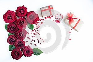 Flat Lay Background, flower pattern, Valentine`s Day, the theme of lovers. Red roses and gifts with ribbons on a white background