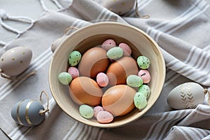 Flat lay of beautiful easter eggs in wooden basket