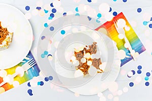 Flat lay with birthday cake pieces on white paper plates. Birthday party celebration concept