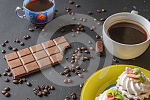 Flat lay of bitten chocolate bar on dark surface f