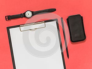 Flat lay black business accessories on pink background with blank space for text. Top view. Copy space.
