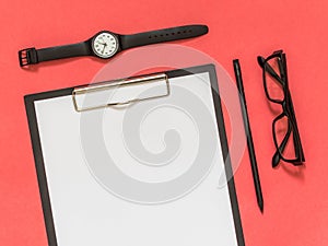 Flat lay black business accessories on pink background with blank space for text. Top view. Copy space.