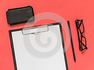 Flat lay black business accessories on pink background with blank space for text. Top view. Copy space.